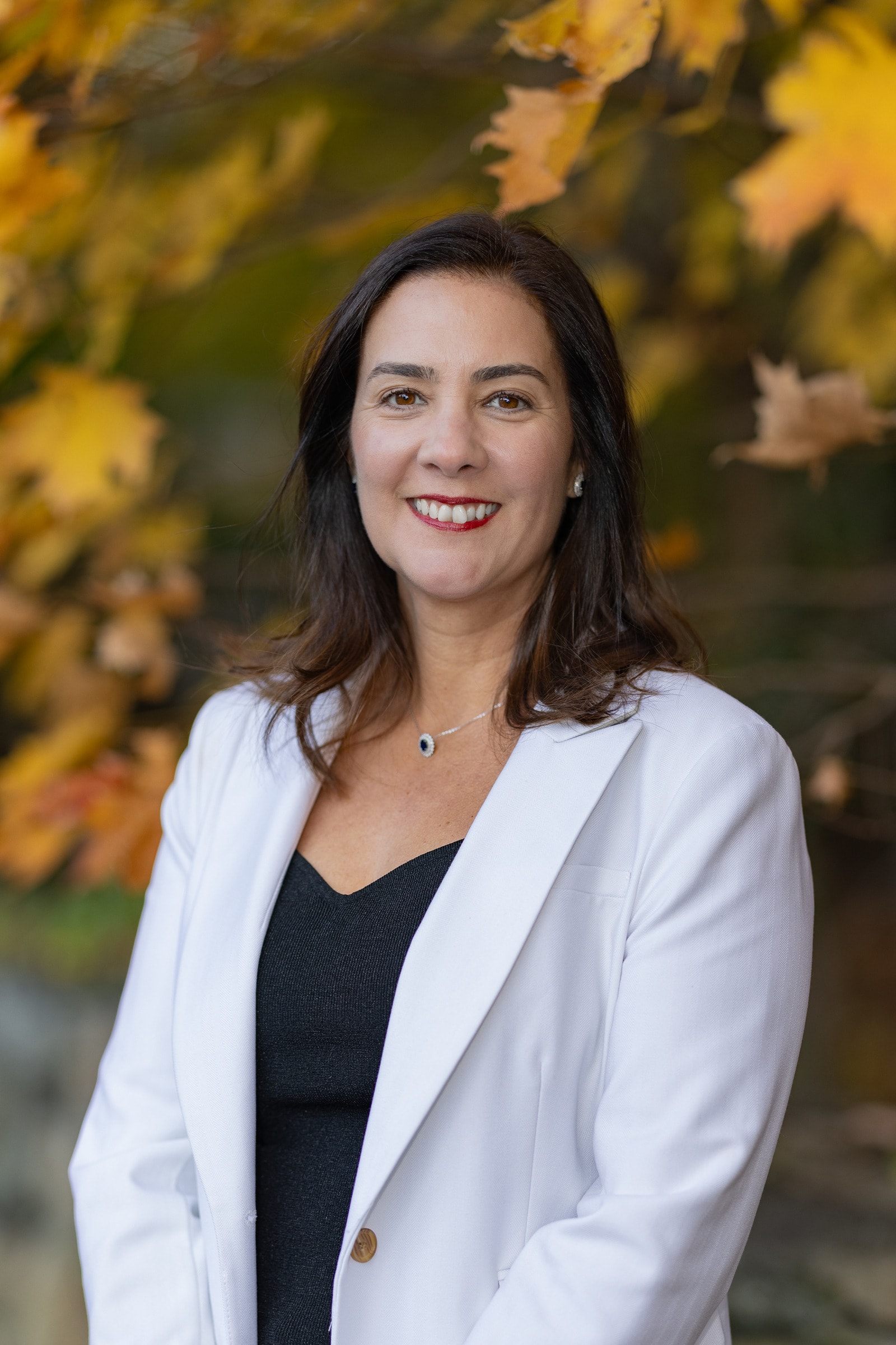 Juliana Serrao among yellow autumn maple leaves